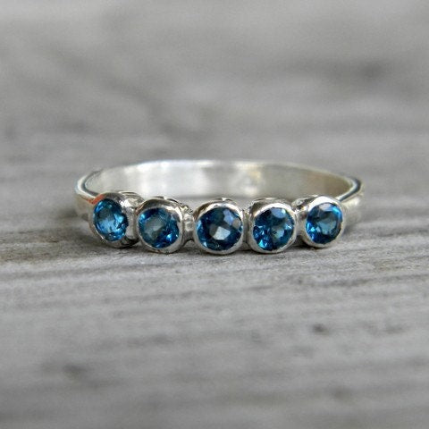 Handmade sterling silver Cassin jewelry featuring London Blue Topaz Five Stone stones.