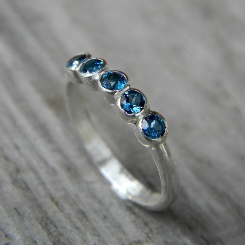A handmade sterling silver ring with London Blue Topaz Five Stone stones by Cassin Jewelry.