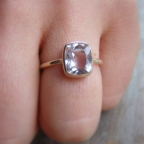 A person wearing a Morganite Ring in Palladium White Gold with a cushion cut sapphire from Cassin Jewelry.