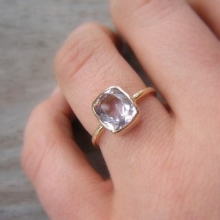 Handmade jewelry featuring a woman wearing a stunning palladium white gold morganite ring adorned with a mesmerizing white topaz stone.