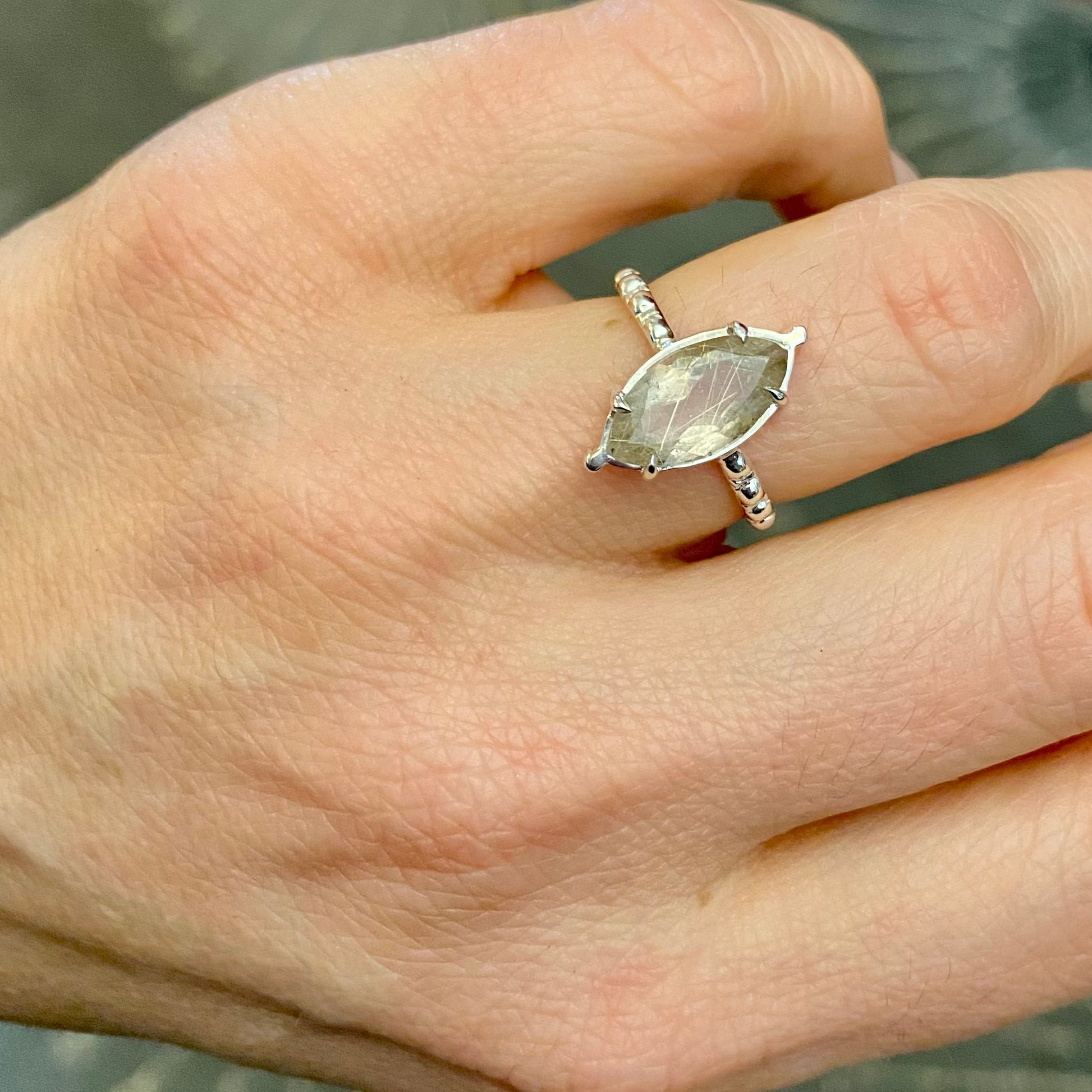 A woman's hand holding a Rutile Quartz and Vintage Sterling Silver Milgrain Band Ring, Diamond Shape Stone Ring, Handmade Marquise Gemstone Prong Setting by Cassin Jewelry