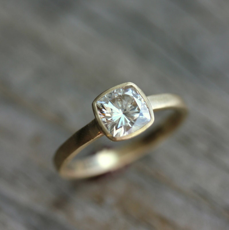 A handmade yellow gold Moissanite engagement ring and wedding band set with a cushion cut diamond.
