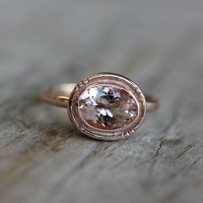 A handmade Oval Morganite 14k Rose Gold Engagement Ring with a morganite stone by Cassin Jewelry.