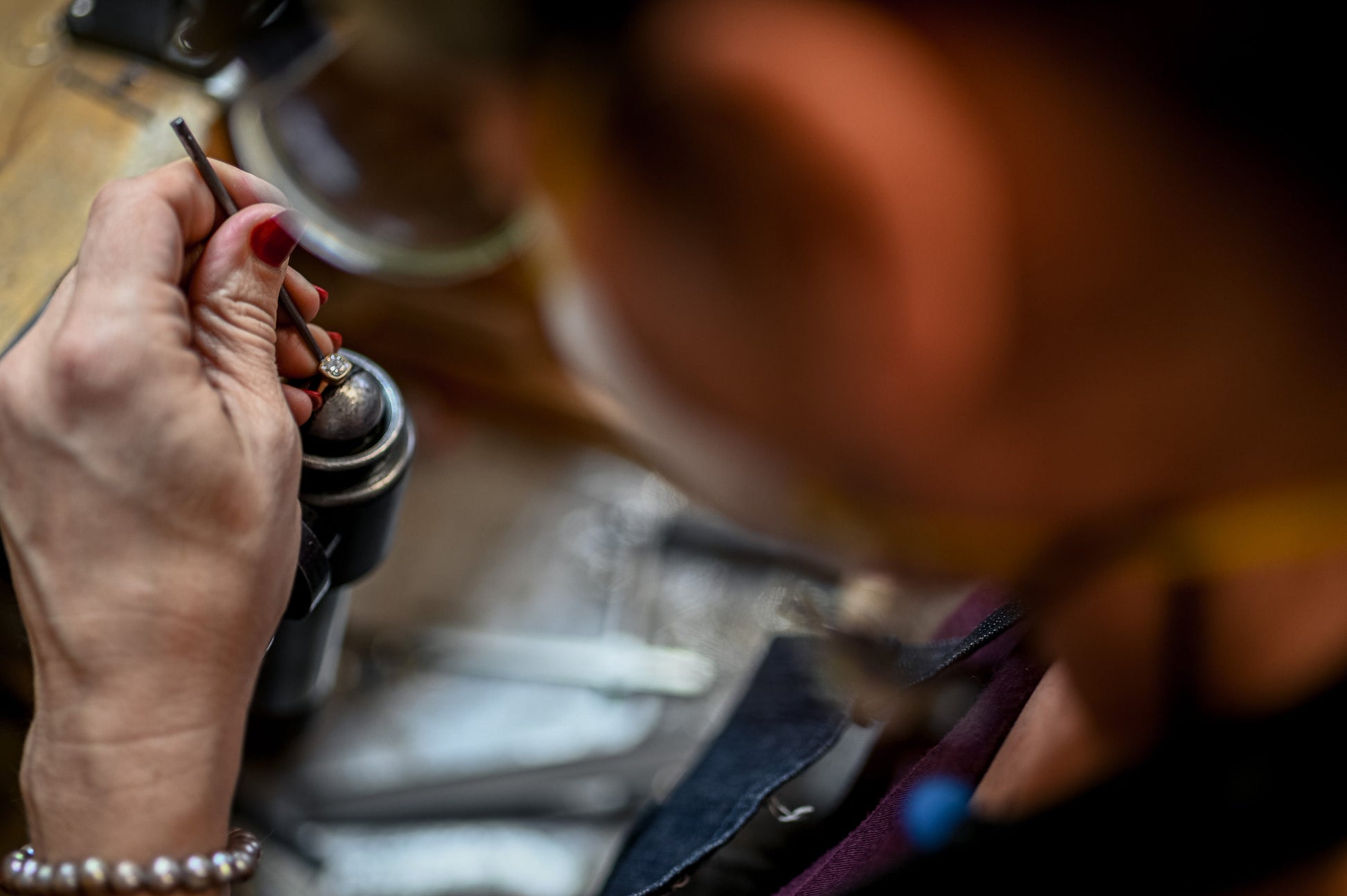 A woman is working on a handmade Oregon Sunstone Milgrain Ring.