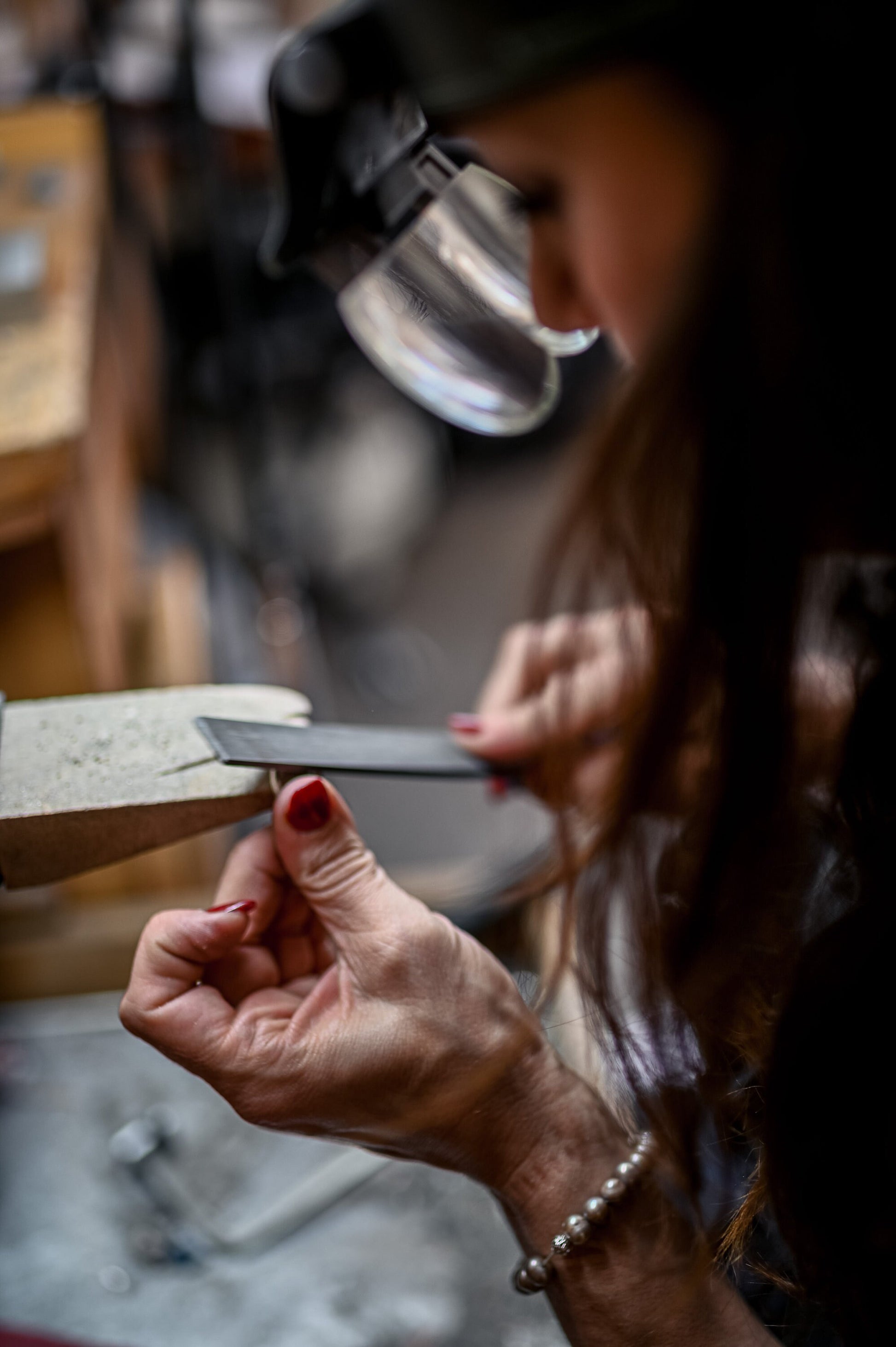 A woman is working on a handmade Round Morganite Ring in White Gold with Cassin Jewelry.