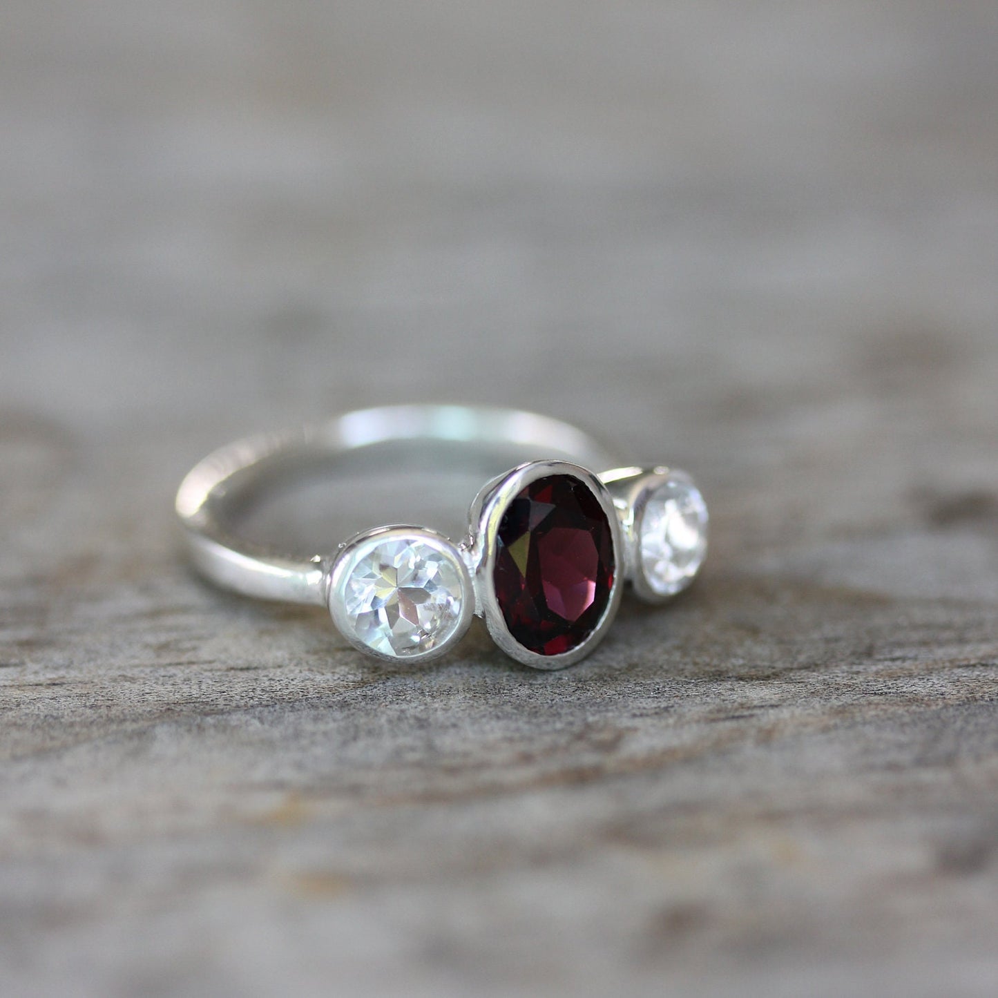 A Pink Garnet Ring with white diamonds, handmade by Cassin Jewelry.