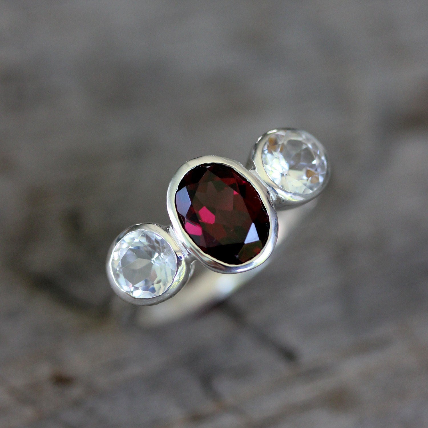 Handmade Pink Garnet Ring adorned with a garnet stone and white topaz by Cassin Jewelry.