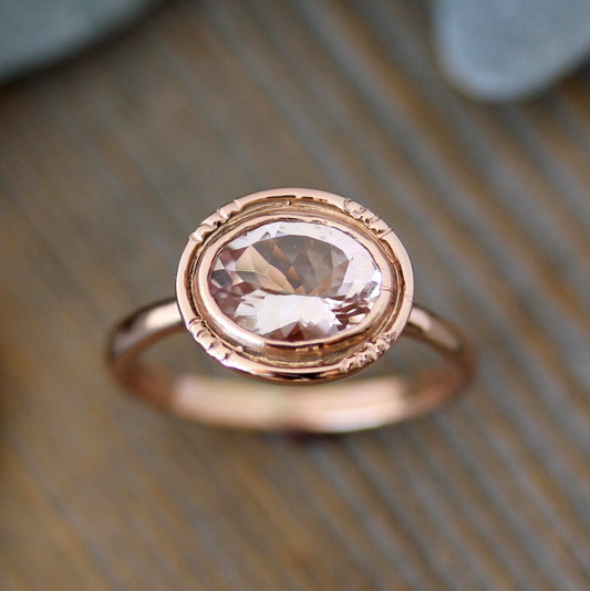 A handmade Oval Morganite 14k Rose Gold Engagement Ring featuring a morganite stone from Cassin Jewelry.
