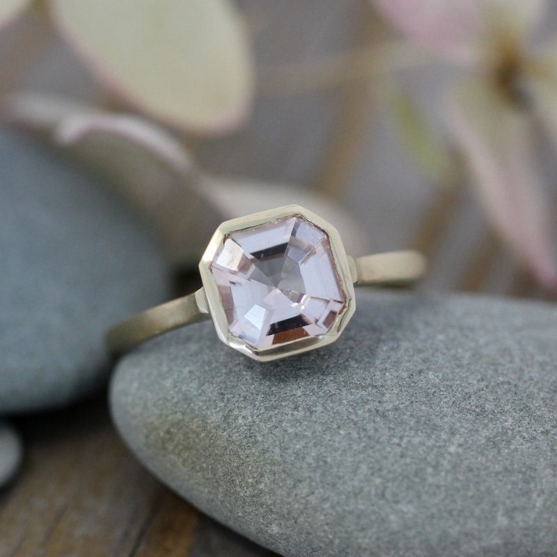 A handmade Asscher Cut Morganite ring in 14k yellow Gold with a pink sapphire.