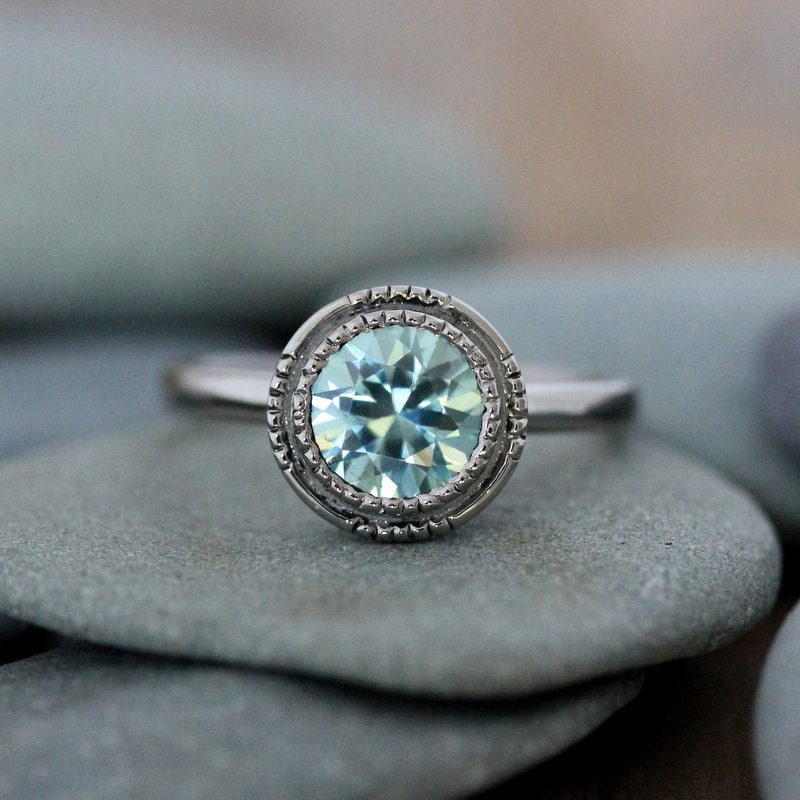 Handmade Light Blue Aqua Zircon Ring adorned with a blue topaz stone on top of rocks from Cassin Jewelry.