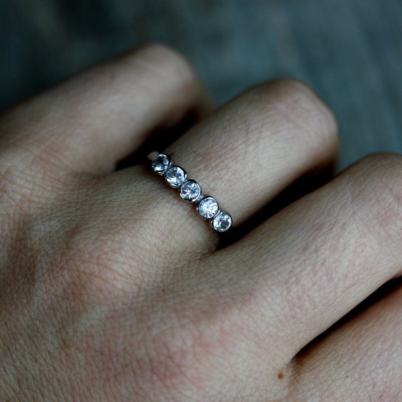 A woman's Handmade White Sapphire Anniversary Band from Cassin Jewelry.