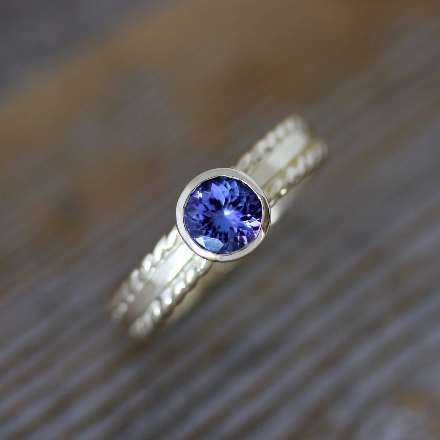 A handmade engagement ring with a Royal Blue Tanzanite and 14k Yellow Gold Gemstone, designed by Cassin Jewelry.