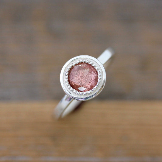 Handmade round Oregon Sunstone ring in sterling silver crafted by Cassin Jewelry.