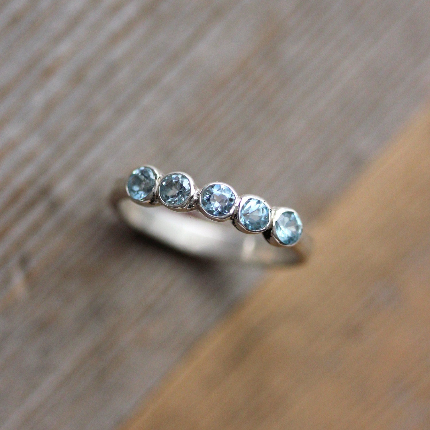 A Cassin Jewelry handmade Sky Blue Topaz Ring with blue topaz stones.
