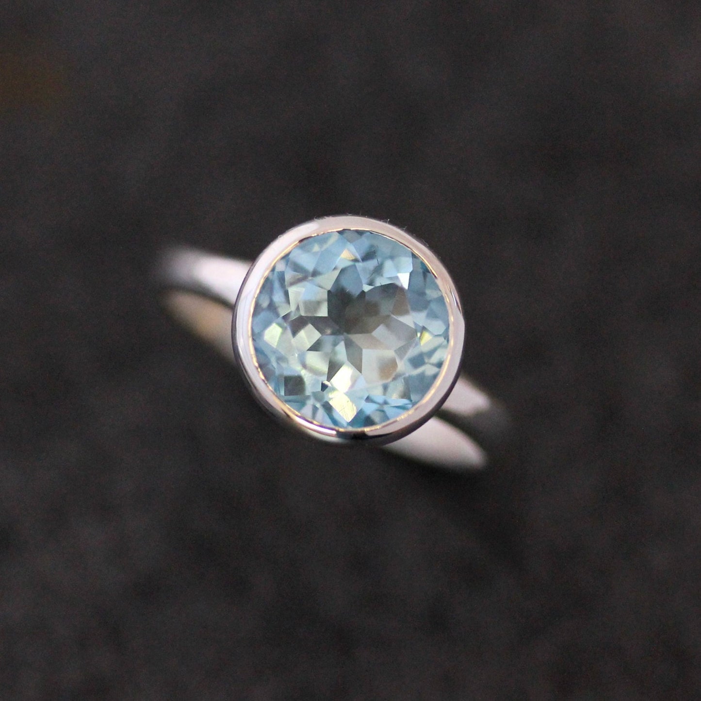 Handmade sterling silver ring with a Sky Blue Topaz Birthstone stone.