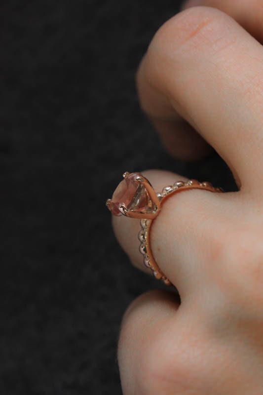 A woman wearing the Peachy Oregon Sunstone Ring in Rose Gold from Cassin Jewelry.