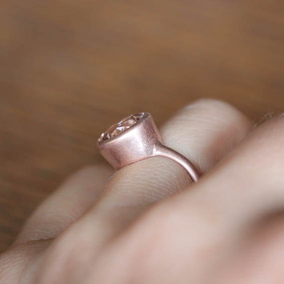 A person wearing a 10mm Round Morganite Rose Gold Gemstone Ring by Cassin Jewelry.