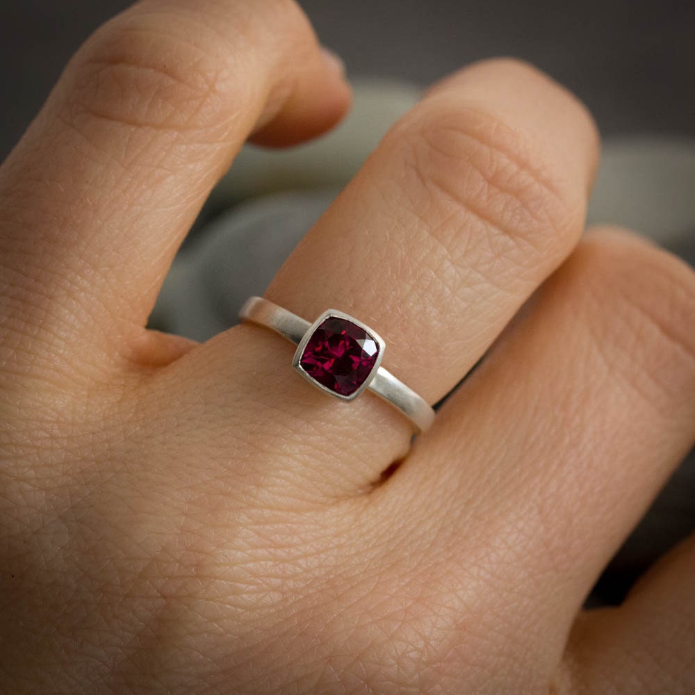 A woman wearing a handmade Pink Garnet Ring from Cassin Jewelry.