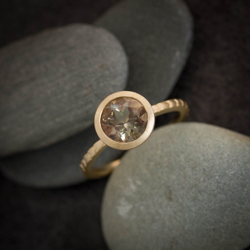 Handmade cassin jewelry featuring an Oregon Sunstone gold ring with a smoky quartz stone.
