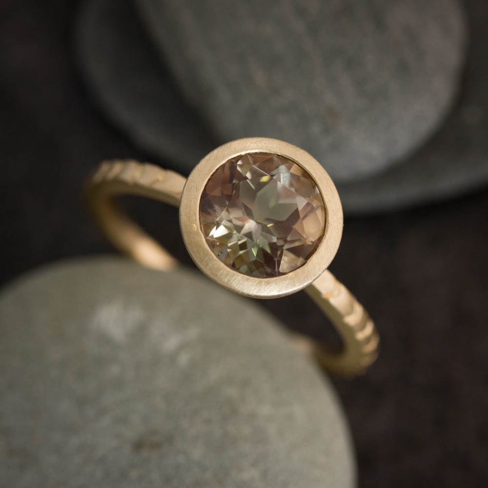 A handmade Oregon Sunstone Gold Ring with a smoky quartz.