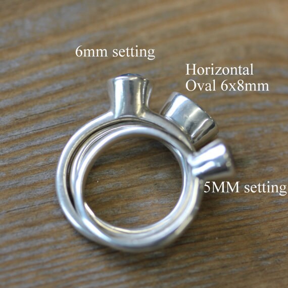 A handmade jewelry ring with a 5mm setting and a 6mm setting, both the Oval Stackable Ring.