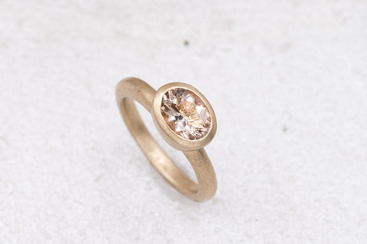 A Handmade Morganite and Yellow Gold Solitaire Ring with a morganite stone.