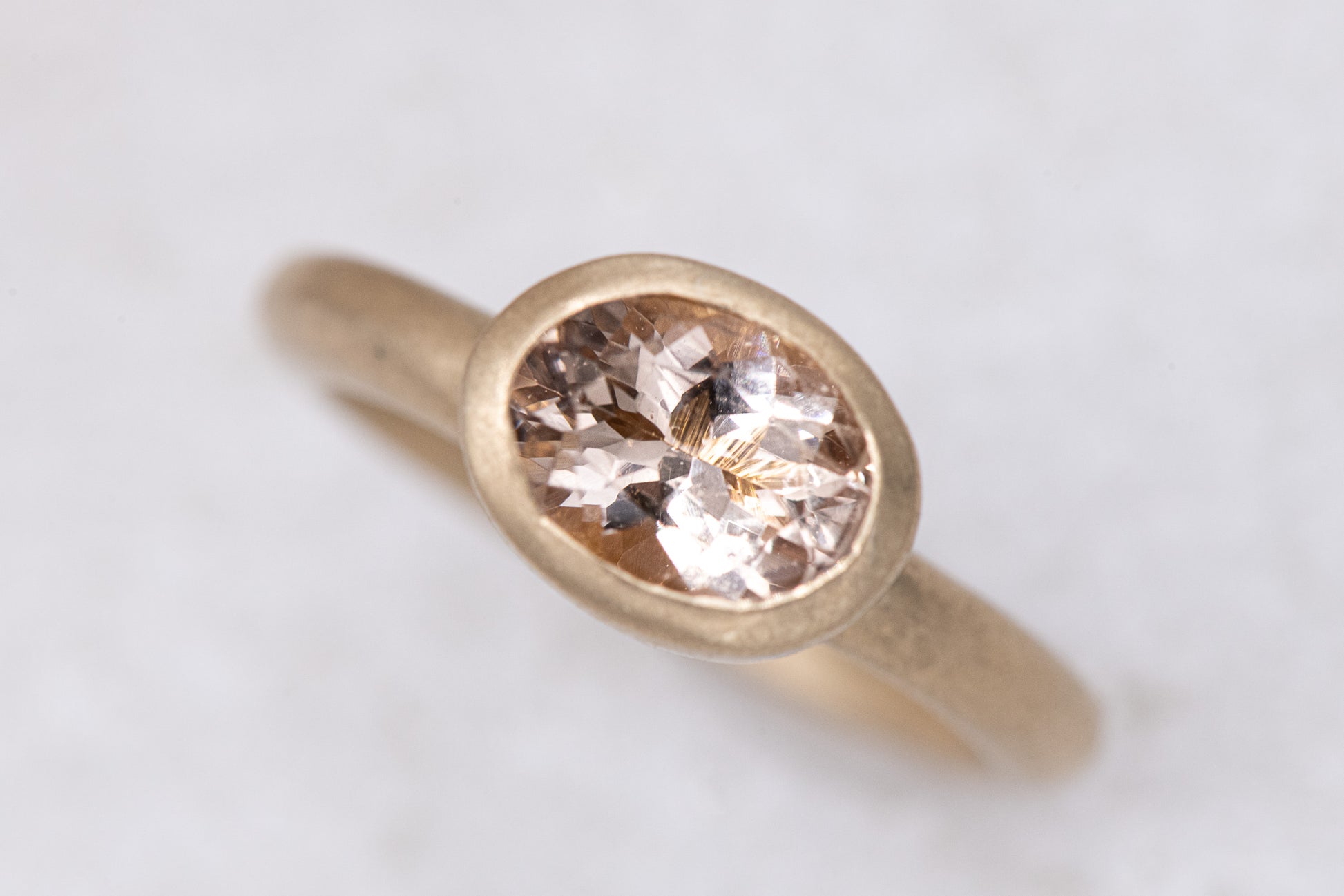 A handmade yellow gold ring with an Oval Morganite stone (Cassin Jewelry).