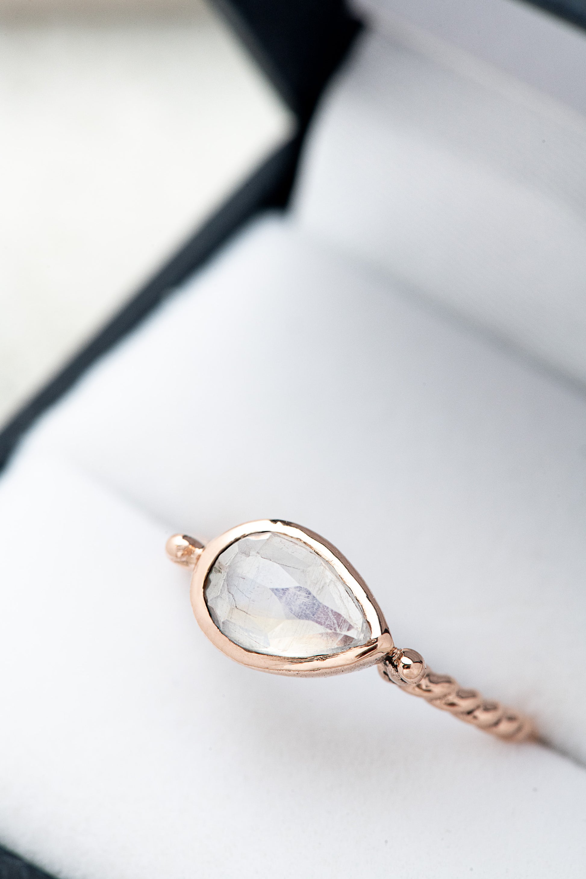 A handmade rose gold Pear Shaped Rainbow Moonstone Ring with a pear shaped stone by Cassin Jewelry.